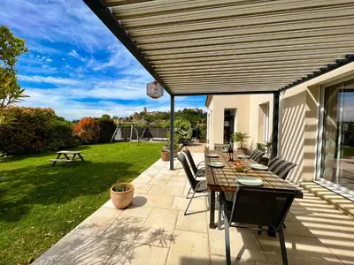 a patio with a table and chairs on a patio at Le temps de vivre in Mormoiron