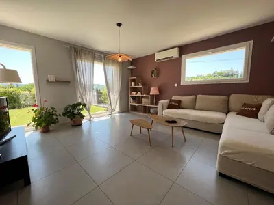 a living room with a couch and a table at Le temps de vivre in Mormoiron