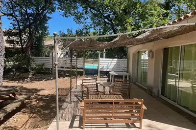 a patio with benches and a table and a swing at Maison confortable à Velleron de 50 m² avec piscine in Velleron