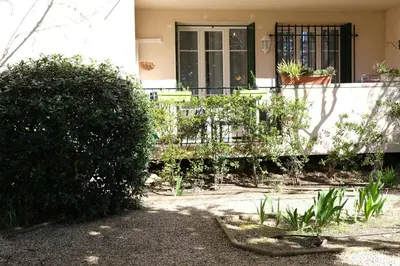 a house with a gate and bushes in front of it at Three bedrooms apartment in Aix en Pce in Aix-en-Provence