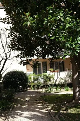 a house with a tree in front of it at Three bedrooms apartment in Aix en Pce in Aix-en-Provence
