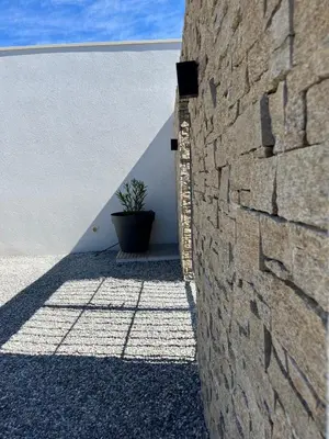 a stone wall with a potted plant next to it at La Réserve Hôtes in Aix-en-Provence