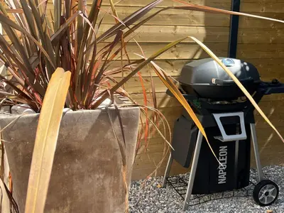 a trash can sitting next to a plant at La Réserve Hôtes in Aix-en-Provence