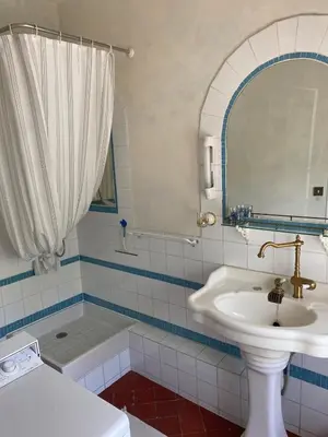 a bathroom with a sink and a mirror and a tub at Syrius - Artist's apartment with terrace and view in Fontaine-de-Vaucluse