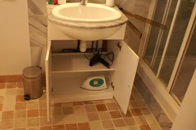 a bathroom with a sink and a scale under it at Catherine&Martial in Maubec