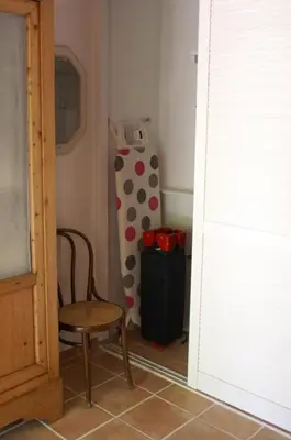 a room with a chair and a refrigerator at Catherine&Martial in Maubec