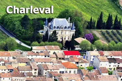 an aerial view of a town with a castle at GitesLuberon 3 in Charleval