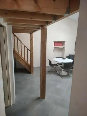 a room with a table and a table and a staircase at GitesLuberon 3 in Charleval