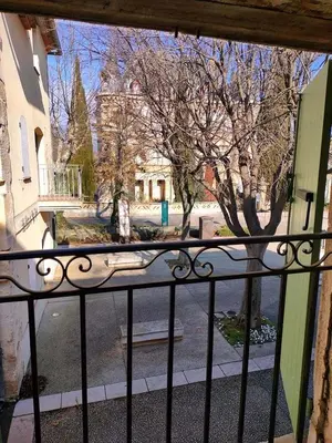 a view of a street from a wrought iron fence at GitesLuberon 3 in Charleval