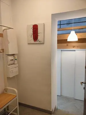 a kitchen with a painting on the wall at GitesLuberon 5 in Charleval