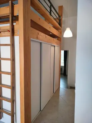 a room with a bunk bed and a ladder at GitesLuberon 5 in Charleval