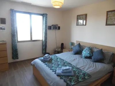 a villa with a swimming pool and two chairs and a house at Coeur de Bonnieux in Bonnieux