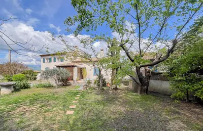 a house with a tree in the yard at Mon coeur de Provence in Banon