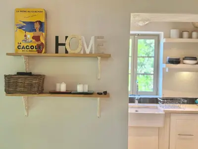 a kitchen with a shelf on the wall at Bastidon Silvestre in Saint-Saturnin-les-Apt