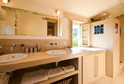 a bathroom with two sinks and a window at Bastidon Silvestre in Saint-Saturnin-les-Apt