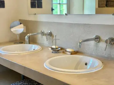 a bathroom counter with two sinks and two faucets at Bastidon Silvestre in Saint-Saturnin-les-Apt