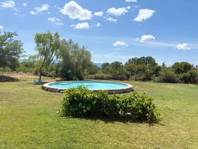 a swimming pool in the middle of a field at Bastidon Silvestre in Saint-Saturnin-les-Apt