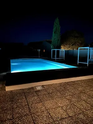 a swimming pool lit up at night at 4 bedroom villa, private pool and garden in Cabrières-dʼAvignon