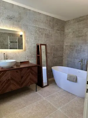 a bathroom with a large tub and a sink at 4 bedroom villa, private pool and garden in Cabrières-dʼAvignon