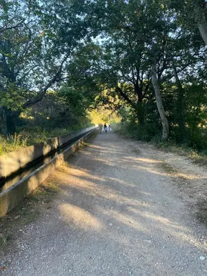 two people walking down a dirt road next to trees at Peaceful Family Retreat In Aix-En-Provence in Puyricard