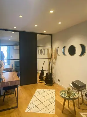 a living room with a table and mirrors on the wall at Peaceful Family Retreat In Aix-En-Provence in Puyricard