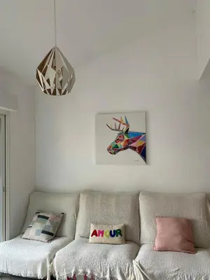 a living room with a couch and a painting of a unicorn at Peaceful Family Retreat In Aix-En-Provence in Puyricard