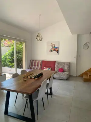 a living room with a wooden table and chairs at Peaceful Family Retreat In Aix-En-Provence in Puyricard