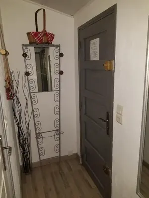 a room with a door and a shelf next to a door at Les Marronniers Charmant petit appartement a La Tour d'Aigues Vaucluse in La Tour-dʼAigues