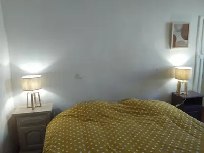 a bedroom with a bed and two lamps on night stands at La Bastide des Jourdans logement entier Duplex in La Bastide-des-Jourdans