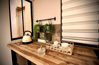 a bathroom counter with a mirror and a sink at L'Or du Temps - Jacuzzi privé in Lançon-Provence