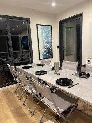 a dining room with a large table and chairs at Appartement neuf avec vue in Mallemort