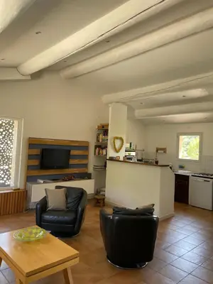 a living room with a couch and a table at Une maison en Provence piscine au pied du Luberon in Mérindol