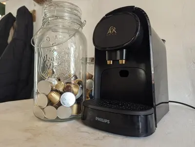 a glass jar with money in it next to a blender at La Bergerie de Lorette - Au Cœur du Luberon in Bonnieux