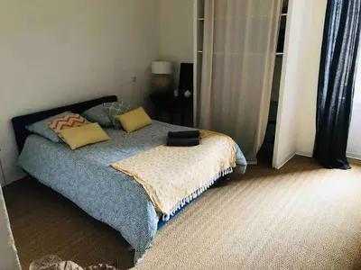 a bedroom with a bed with pillows on it at Lubéron Grde Maison de village avec terrasse 4 chambres doubles in Saint-Martin-de-Castillon