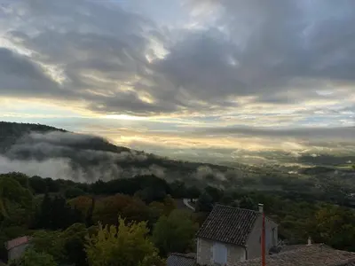 a view of a foggy valley with a house at Lubéron Grde Maison de village avec terrasse 4 chambres doubles in Saint-Martin-de-Castillon