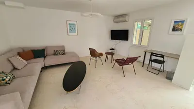 a living room with a couch and a table and chairs at 140 m2 villa with pool in Pernes-Les-Fontaines in Pernes-les-Fontaines