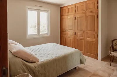 a bedroom with a bed and a window at La Villa Des Garrigues in Mazan