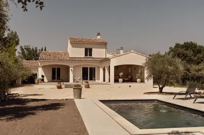 a house with a swimming pool in front of it at La Villa Des Garrigues in Mazan