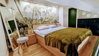 a bedroom with a bed with a painting on the wall at Lovely Apartment with a Rooftop View in Aix in Aix-en-Provence