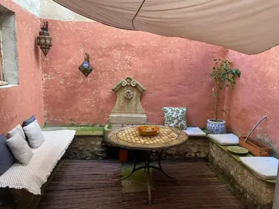an outdoor patio with a table and a chair at appartement de charme in Lançon-Provence
