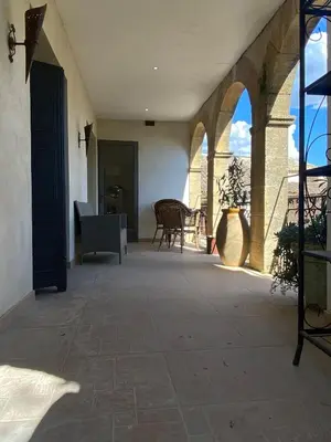 an outdoor patio with a table and a chair at appartement de charme in Lançon-Provence