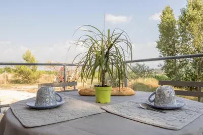 a table with two hats and a plant on it at La Luberonnette in Saint-Saturnin-les-Apt