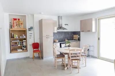 a kitchen and dining room with a table and chairs at La Luberonnette in Saint-Saturnin-les-Apt