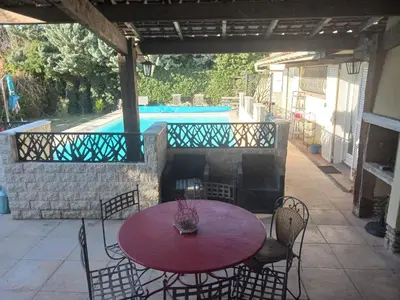 a table and chairs on a patio with a pool at MAISON Terrasse PISCINE in Cavaillon