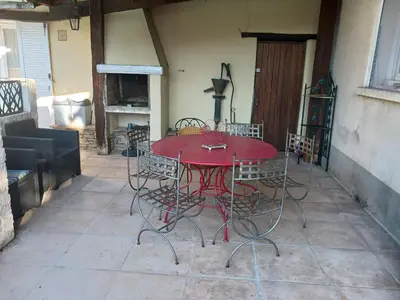 a red table and chairs on a patio at MAISON Terrasse PISCINE in Cavaillon