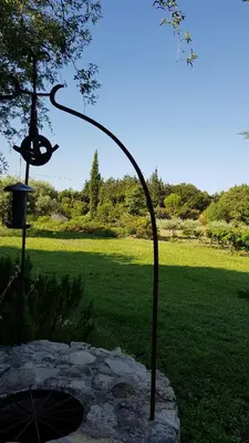 a metal sculpture of a bird feeder in a park at Provencal Farmhouse With Mont Ventoux Views in Carpentras