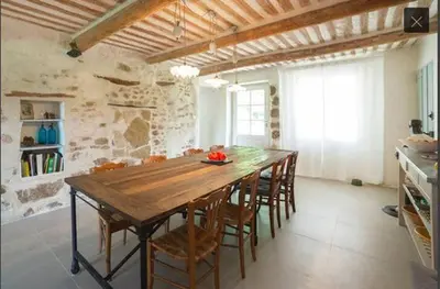 a dining room with a wooden table and chairs at Provencal Farmhouse With Mont Ventoux Views in Carpentras