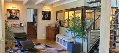 a living room with a staircase and a couch and chairs at Maison de charme à Aix-en-Provence in Aix-en-Provence