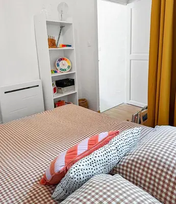 a bedroom with a bed with two pillows on it at Grand appartement spacieux et lumineux à Noves in Noves