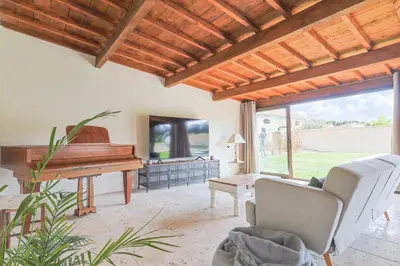 a living room with a piano and a couch at Le Champ des Cigales in Noves